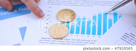 Golden btc sign coin lying at stats graph closeup Golden btc sign coin lying at stats graph closeup 47920565