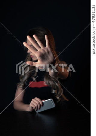 Woman with negative surprised face looking something in smartphone. Sad teenager with mobile phone Woman with negative surprised face looking something in smartphone. Sad teenager with mobile phone 47921132