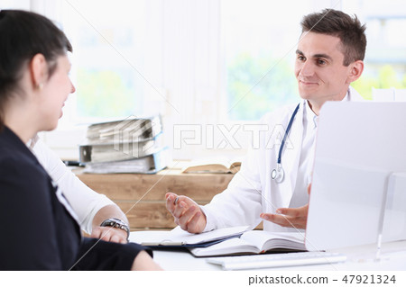 Male family doctor listen carefully young Male family doctor listen carefully young 47921324