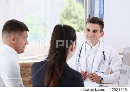 Male family doctor listen carefully young Male family doctor listen carefully young 47921329