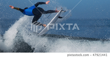 Sports man surfing wave on surfboard in ocean Sports man surfing wave on surfboard in ocean 47921441
