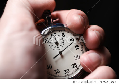 Male hand starts the analog stopwatch Male hand starts the analog stopwatch 47921598