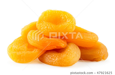 Heap of dried apricots closeup on a white Heap of dried apricots closeup on a white 47921625