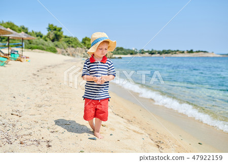 Toddler boy on beach Toddler boy on beach 47922159