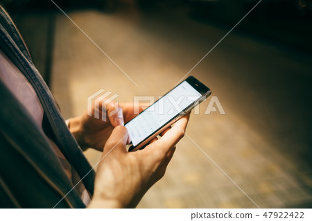 Female's hands holding mobile phone Female's hands holding mobile phone 47922422