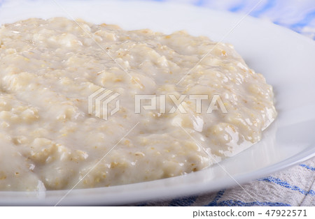 Healthy oatmeal closeup on a white plate 47922571