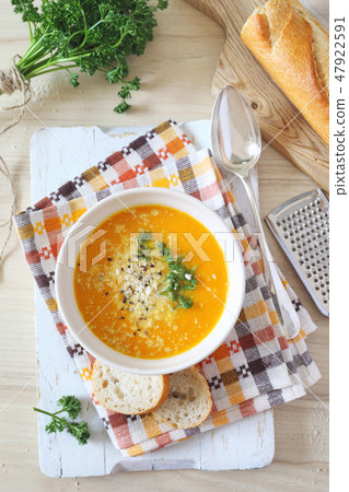 Carrot cream soup with parsley, cheese, baguette 47922591