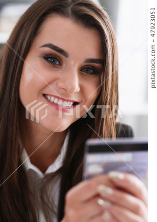 Business woman in the office holds plastic credit 47923051