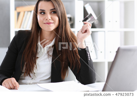 Business woman in the office holds plastic credit 47923073