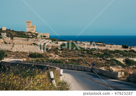 Man and woman sitting on the stone Man and woman sitting on the stone 47923287