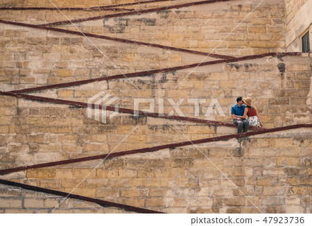 Man kissing woman on the city walls 47923736