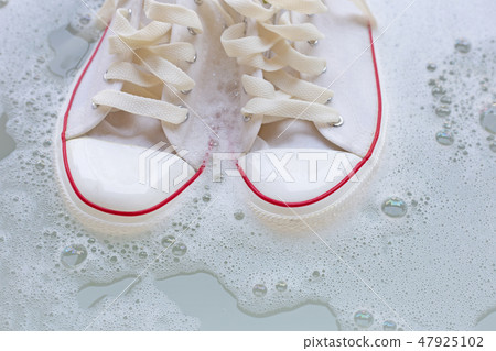 Soak shoes before washing. Dirty sneakers. 47925102