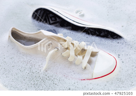 Soak shoes before washing. Dirty sneakers. 47925103