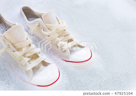 Soak shoes before washing. Dirty sneakers. 47925104