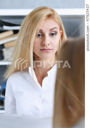 Beautiful woman portrait at workplace examining Beautiful woman portrait at workplace examining 47925437