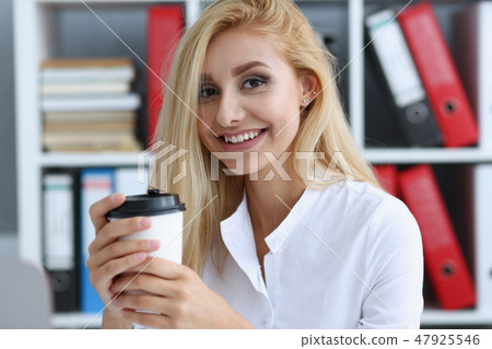 Smiling business woman drinking coffee from 47925546