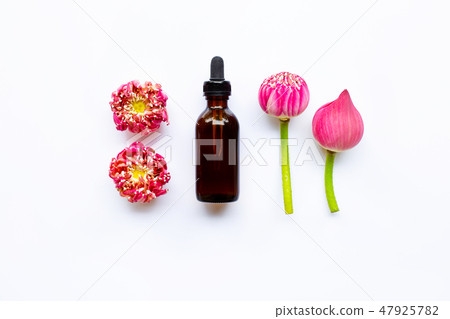 Lotus essential oil with lotus flowers on white. Lotus essential oil with lotus flowers on white. 47925782
