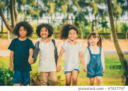 Happy kids group playing in the park in school. 47927797