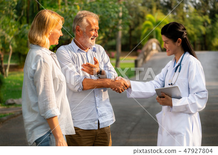 Senior couple talking to nurse or caregiver. 47927804