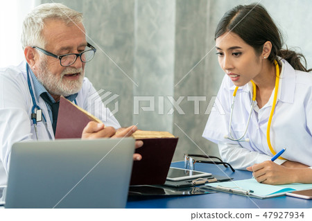 Senior male doctor working with another doctor. Senior male doctor working with another doctor. 47927934
