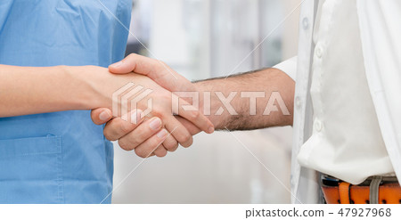 Doctor in hospital handshake with another doctor. 47927968