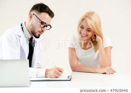 Male Doctor and Female Patient in Hospital Office Male Doctor and Female Patient in Hospital Office 47928048