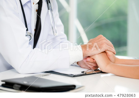 Male Doctor and Female Patient in Hospital Office Male Doctor and Female Patient in Hospital Office 47928063