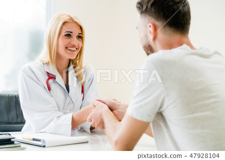 Woman Doctor and Male Patient in Hospital Office Woman Doctor and Male Patient in Hospital Office 47928104