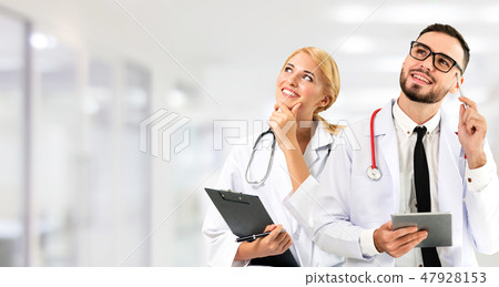 Doctor at hospital works on computer with partner. Doctor at hospital works on computer with partner. 47928153