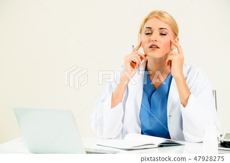 Doctor in hospital working on medical report. 47928275