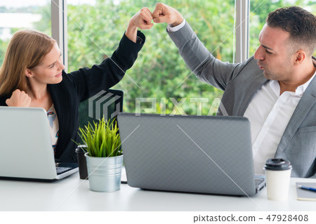 Success business partner celebrating in office. 47928408