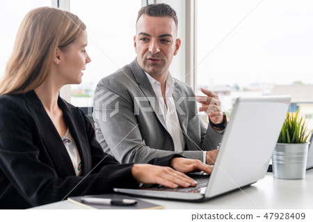 Businessman and businesswoman working in office. Businessman and businesswoman working in office. 47928409