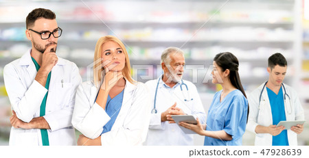 Doctor working in hospital with other doctors. 47928639