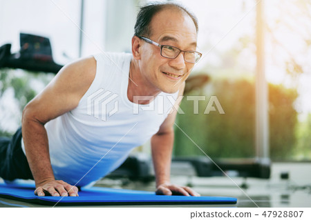 Senior man push up in fitness gym. 47928807