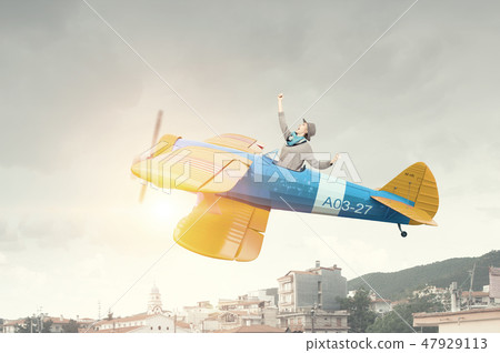 Girl flying old plane 47929113