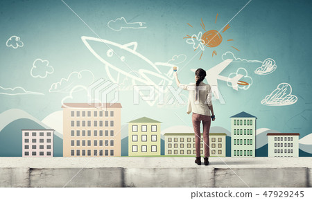 Girl drawing rocket 47929245