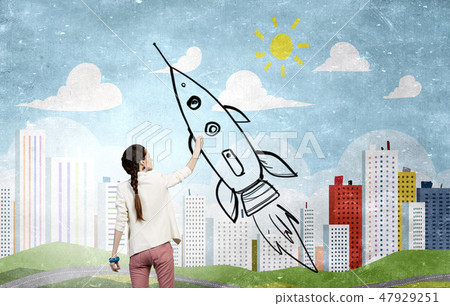 Girl drawing rocket 47929251