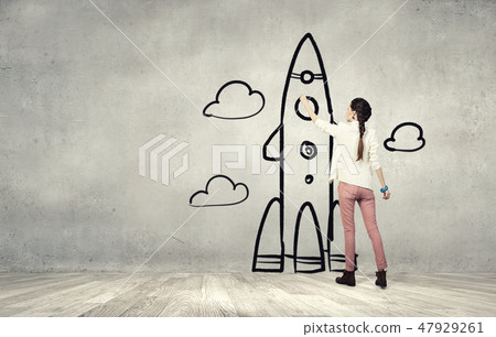 Girl drawing rocket 47929261