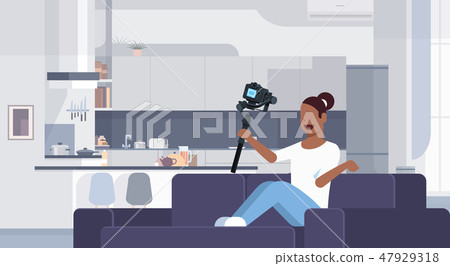 girl blogger recording video on camera african american woman sitting on couch modern kitchen girl blogger recording video on camera african american woman sitting on couch modern kitchen 47929318