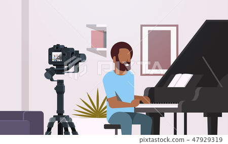 guy musical blogger recording video on camera african american man playing classical piano music guy musical blogger recording video on camera african american man playing classical piano music 47929319
