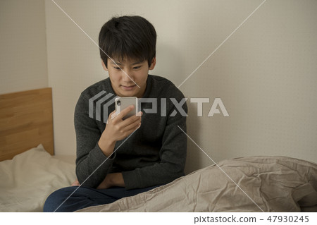 A boy who uses smartphone in bed sleep sleepy junior high school student high school student A boy who uses smartphone in bed sleep sleepy junior high school student high school student 47930245
