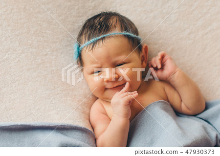 the face of a schild with a bandage on his head close-up 47930373