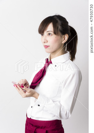 A woman who places an order on a mobile terminal A woman who places an order on a mobile terminal 47930730