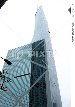 Glass facade skyscraper in urban architecture. Bottom view building with glass facade in modern Hong Glass facade skyscraper in urban architecture. Bottom view building with glass facade in modern Hong 47931114