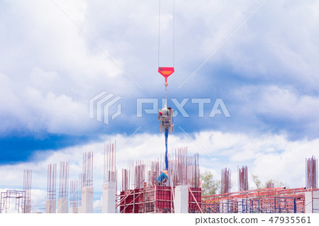 crane lifting concrete mixer container and worker 47935561