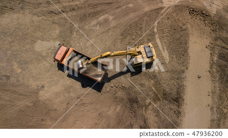Aerial photo of excavator pours sand into the truck. 47936200