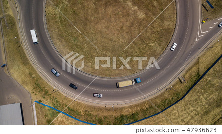 Aerial view of transport junction, traffic cross road junction day view from above with circle road. Aerial view of transport junction, traffic cross road junction day view from above with circle road. 47936623