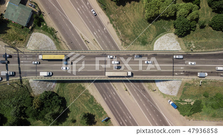 Aerial view of highway and overpass in city on a cloudy day Aerial view of highway and overpass in city on a cloudy day 47936858