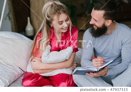 young couple bed anniversary planning make notes young couple bed anniversary planning make notes 47937315