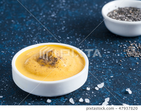 Vegan creamy cheddar cheese sauce with chia seeds 47937820